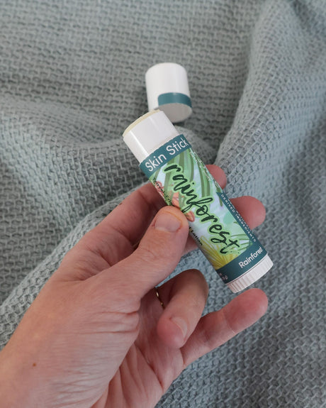 Rainforest solid lotion stick — coconut and sandalwood in a twist-up bar of moisture. Rinse Bath & Body Co.