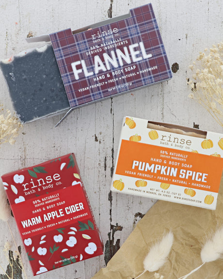 Three Fall Scented bars of soap with their packaging on a wooden surface