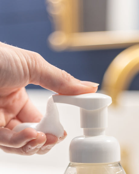 Lavender foaming hand soap pump in use