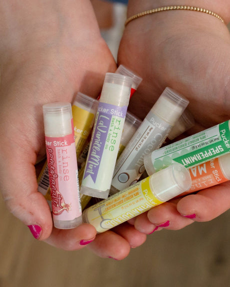 Violet lip balm — soft, powdery florals that taste the way the flower smells. Rinse Bath & Body Co.