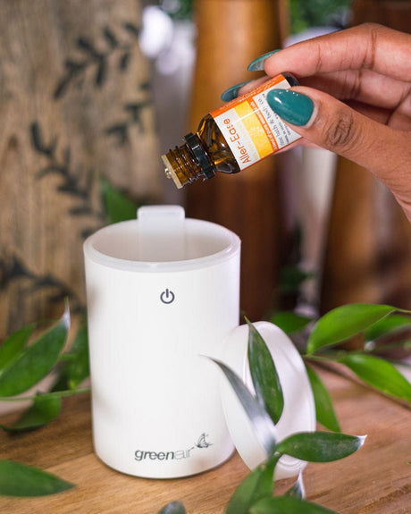 Aller-Ease essential oil blend held in hand — certified organic eucalyptus, peppermint and lavender for easier breathing. Rinse Bath & Body Co.