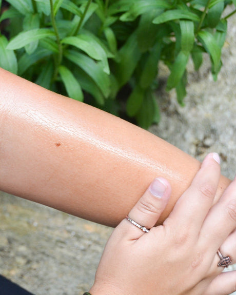 Almond & Honey Body Bliss oil smoothed into skin — warm almond, honey and a soft, non-greasy finish. Rinse Bath & Body Co.