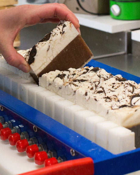 Chocolate bar soap, cocoa-dark and hand-poured — real cocoa in a rich, creamy lather. Rinse Bath & Body Co.