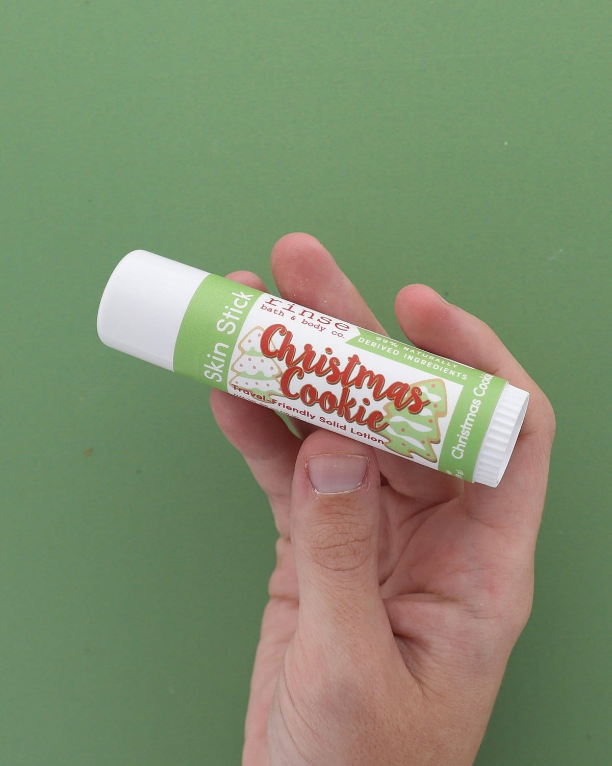 Christmas Cookie Skin Stick solid lotion stylized — sugar-cookie twist-up moisture bar on bright white