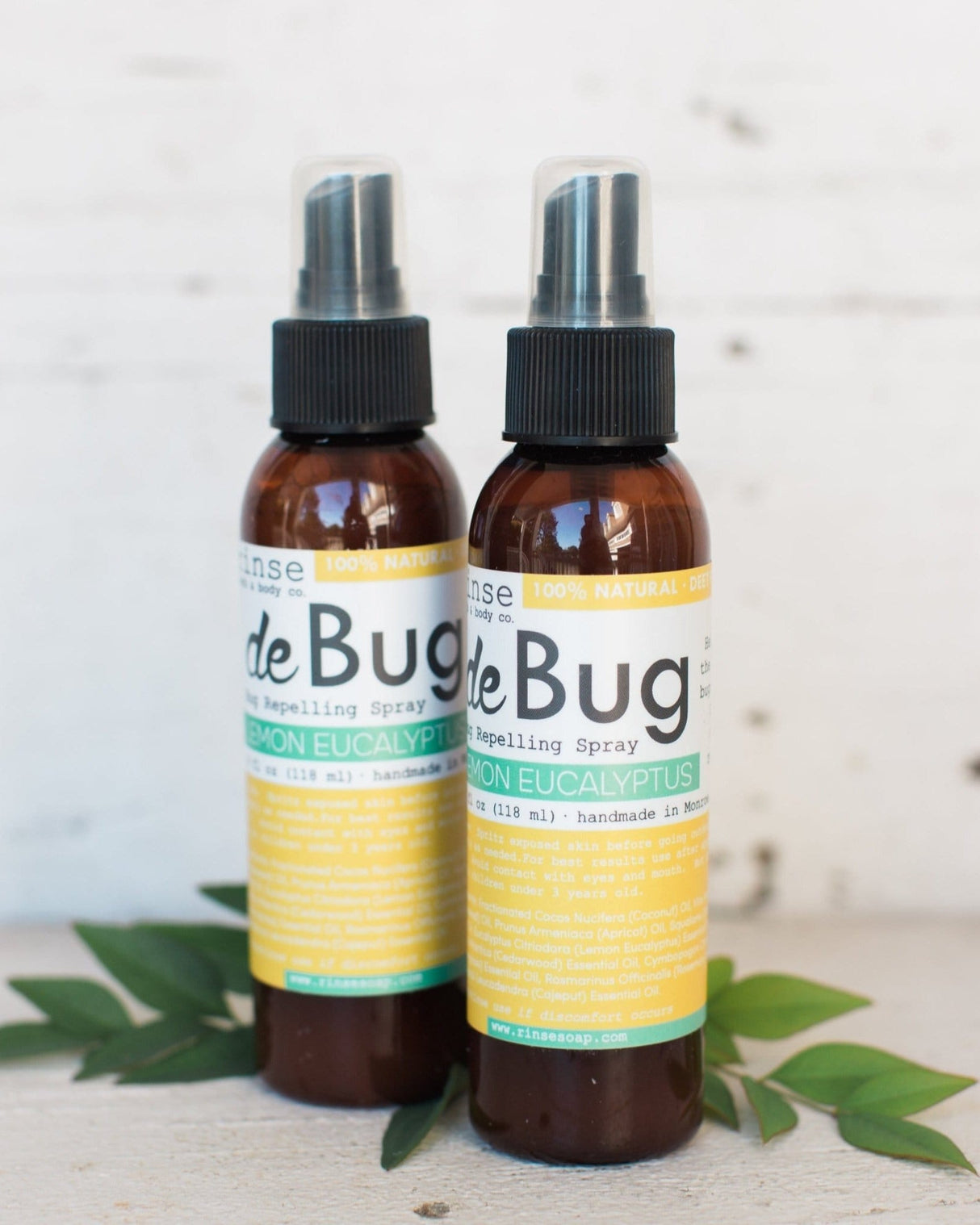 Two DeBug natural DEET-free bug repellent spray bottles by Rinse Bath & Body