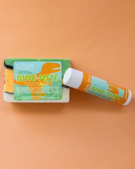 Dino-Mite solid lotion stick — a playful twist-up moisture bar built for small hands. Rinse Bath & Body Co.