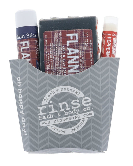 The Flannel fry-box gift set in its grey chevron carton — Flannel bar soap, Flannel solid lotion stick and a Peppermint lip balm, ready to hand over. Rinse Bath & Body Co.