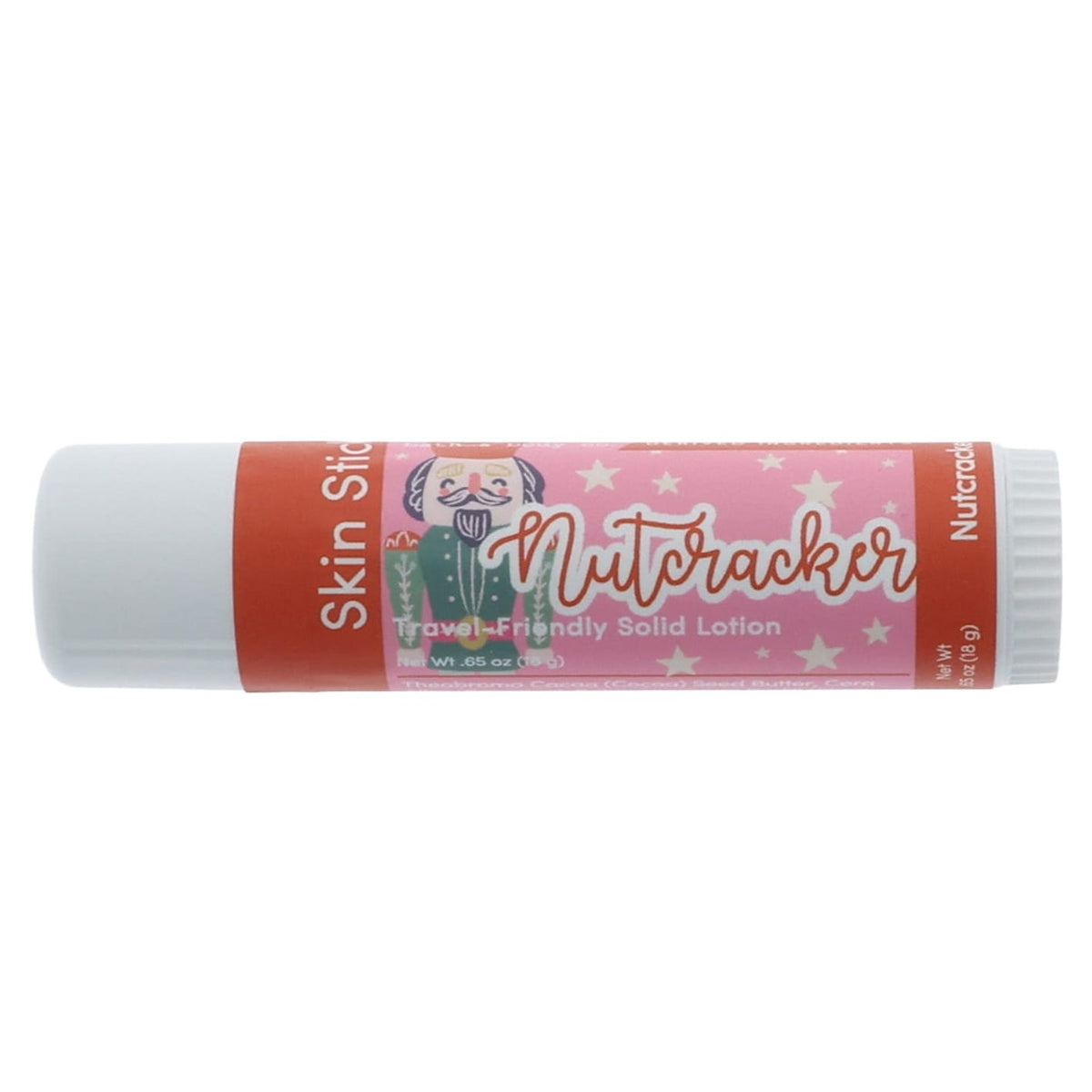 Nutcracker Skin Stick lying on bright white — pink star label and soldier art in clean studio light