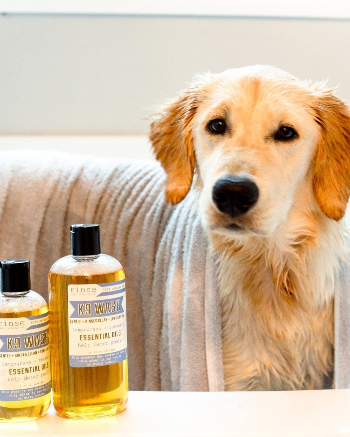 Rinse K9 Wash 8 fl oz bottle, label detail showing the lemongrass and rosemary essential oil blend
