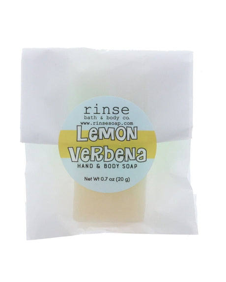 Lemon Verbena soap slice in translucent glassine — yellow-blue circle sticker on clean bright white