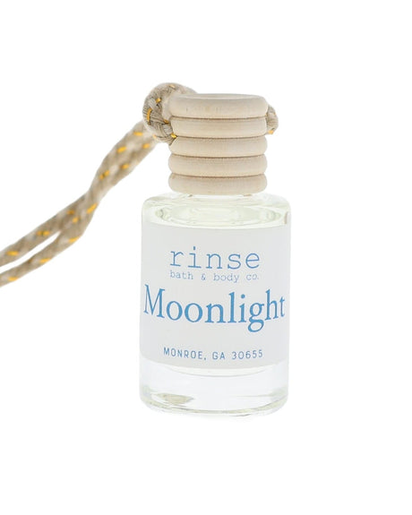 Small bottle labeled 'Moonlight' with a string on a white background