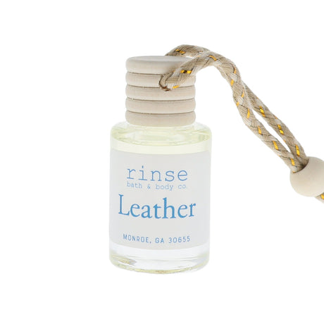 Small bottle labeled 'rinse bath & body co Leather' with a rope attachment on a white background