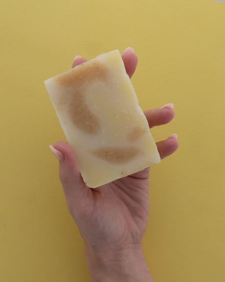 Rinse handmade bar soap styled on a wooden surface