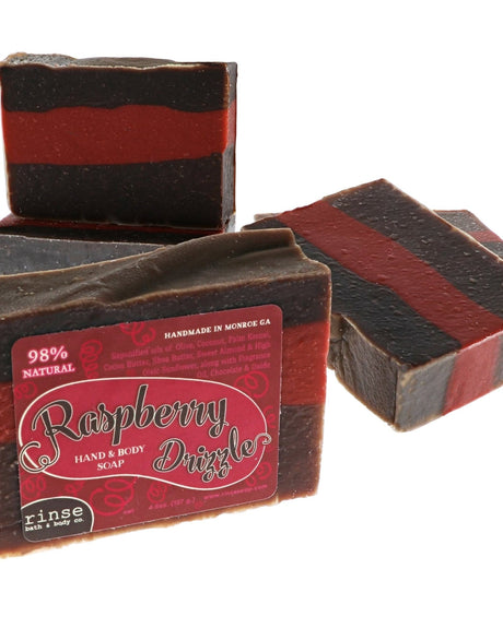 Raspberry Drizzle soap stack shows dark red and brown stripes — script label on clean bright white