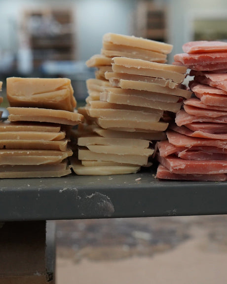 Rows of Rinse soap bars stacked on a wooden table