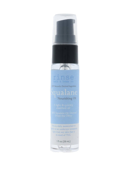 Squalane Nourishing Oil pump bottle stands centered — pale blue label on sterile white