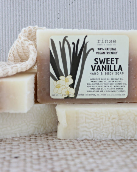 Sweet Vanilla bar soap styled on a warm neutral ground — soft, bakery-sweet vanilla for an everyday shower. Rinse Bath & Body Co.