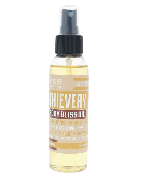 Thievery Body Bliss oil in its amber bottle — the warm four-thieves blend in a lightweight oil that leaves a soft sheen, not a slick. Rinse Bath & Body Co.