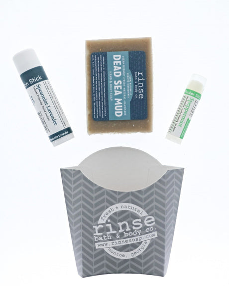 The Dead Sea Mud set laid out flat — bar soap, Spearmint Lavender solid lotion stick and Speppermint lip balm above the grey chevron carton. Rinse Bath & Body Co.