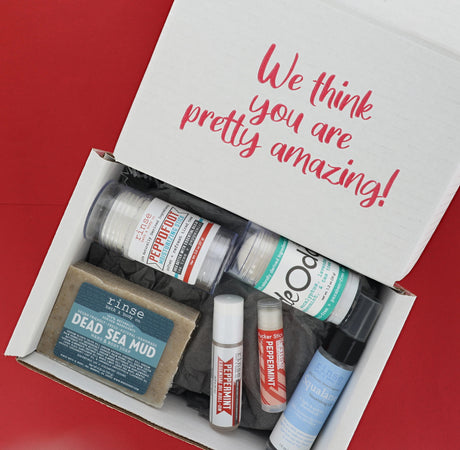 An open Going Natural discovery box with its products arranged inside and the printed flap reading “We think you are pretty amazing!” — six full-size Rinse products, ready to give as shipped. Rinse Bath & Body Co.