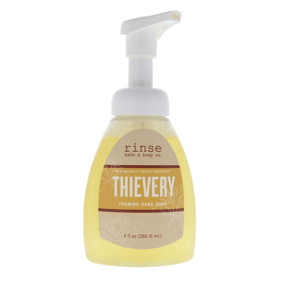 Thievery Foaming Hand Soap standing on bright white — amber liquid and tan label in clean studio light