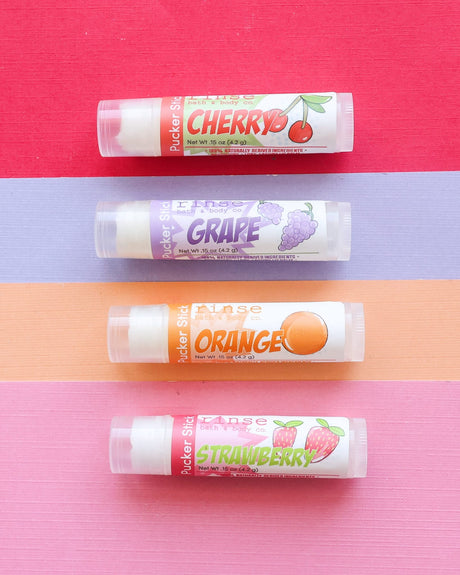 Orange lip balm in its twist-up tube — a pop of citrus punch for kids and adults. Rinse Bath & Body Co.