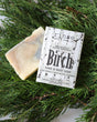 Birch bar soap styled on a cool neutral ground, charcoal swirl running through the top — crisp woodsy birch for a fresh, grounding shower. Rinse Bath & Body Co.