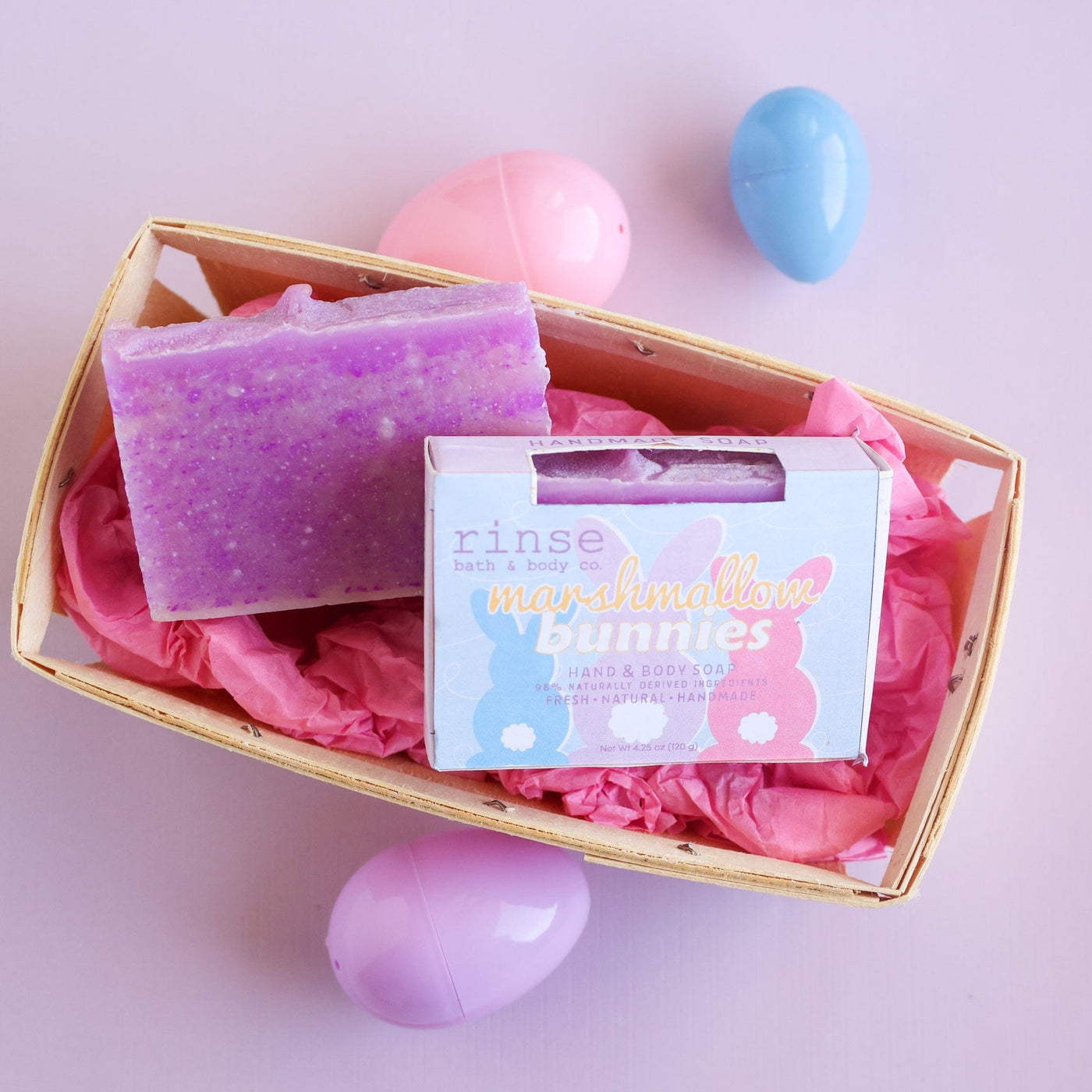 Easter lifestyle — Marshmallow Bunnies soap on wooden tray with pink eggs. Text-free, hero-ready.