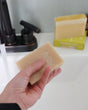 Merlot bar soap styled close, its wine-red marbling running through the cream — real merlot in the batch. Rinse Bath & Body Co.