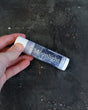 Moonlight solid lotion stick — orange blossom, patchouli and musk in a twist-up bar. Rinse Bath & Body Co.