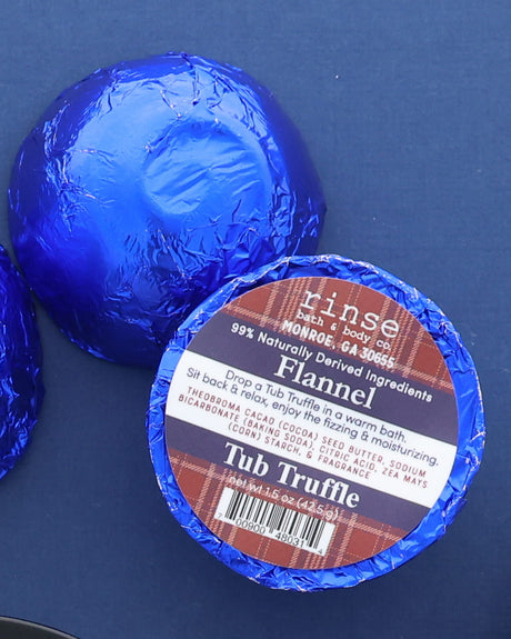 Flannel Tub Truffle wrapped in blue foil on a blue background