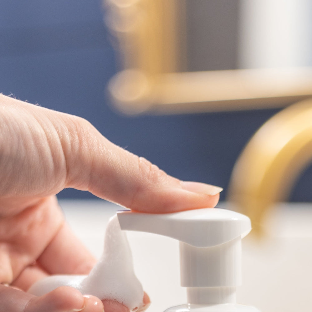 Lavender foaming hand soap pump in use