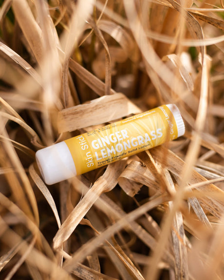 Ginger Lemongrass solid lotion stick — sharp ginger and bright lemongrass in a twist-up bar. Rinse Bath & Body Co.
