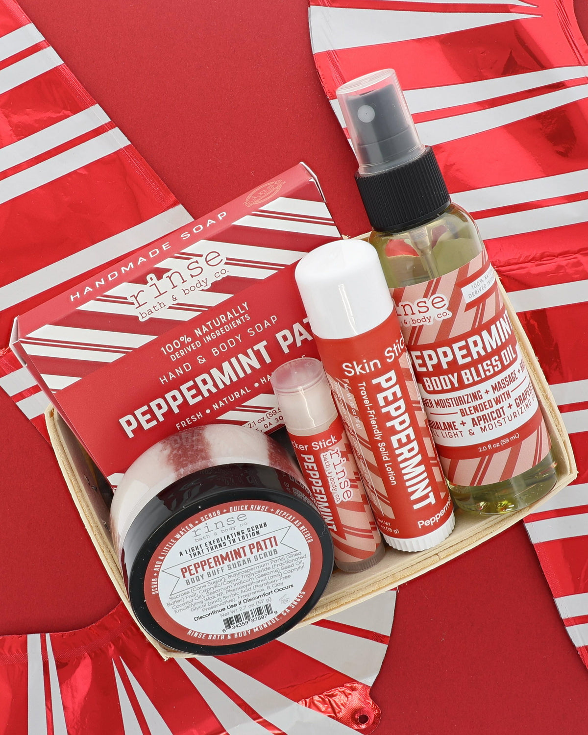 Peppermint Patti travel gift set packed in a berry till on red and white candy-stripe foil, labels facing up