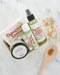 Christmas Cookie travel gift set with soap, body buff, sticks and body oil in a berry till on marble with gold sugar