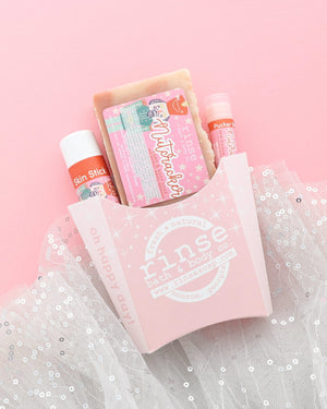 Nutcracker gift set in a pink fry carton with soap, Skin Stick and Pucker Stick on pink with sparkly white tulle