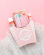 Nutcracker gift set in a pink fry carton with soap, Skin Stick and Pucker Stick on pink with sparkly white tulle