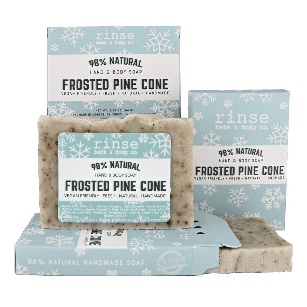 Mini Frosted Pine Cone soap and open snowflake box on deep green — rustic flecked bar in studio contrast