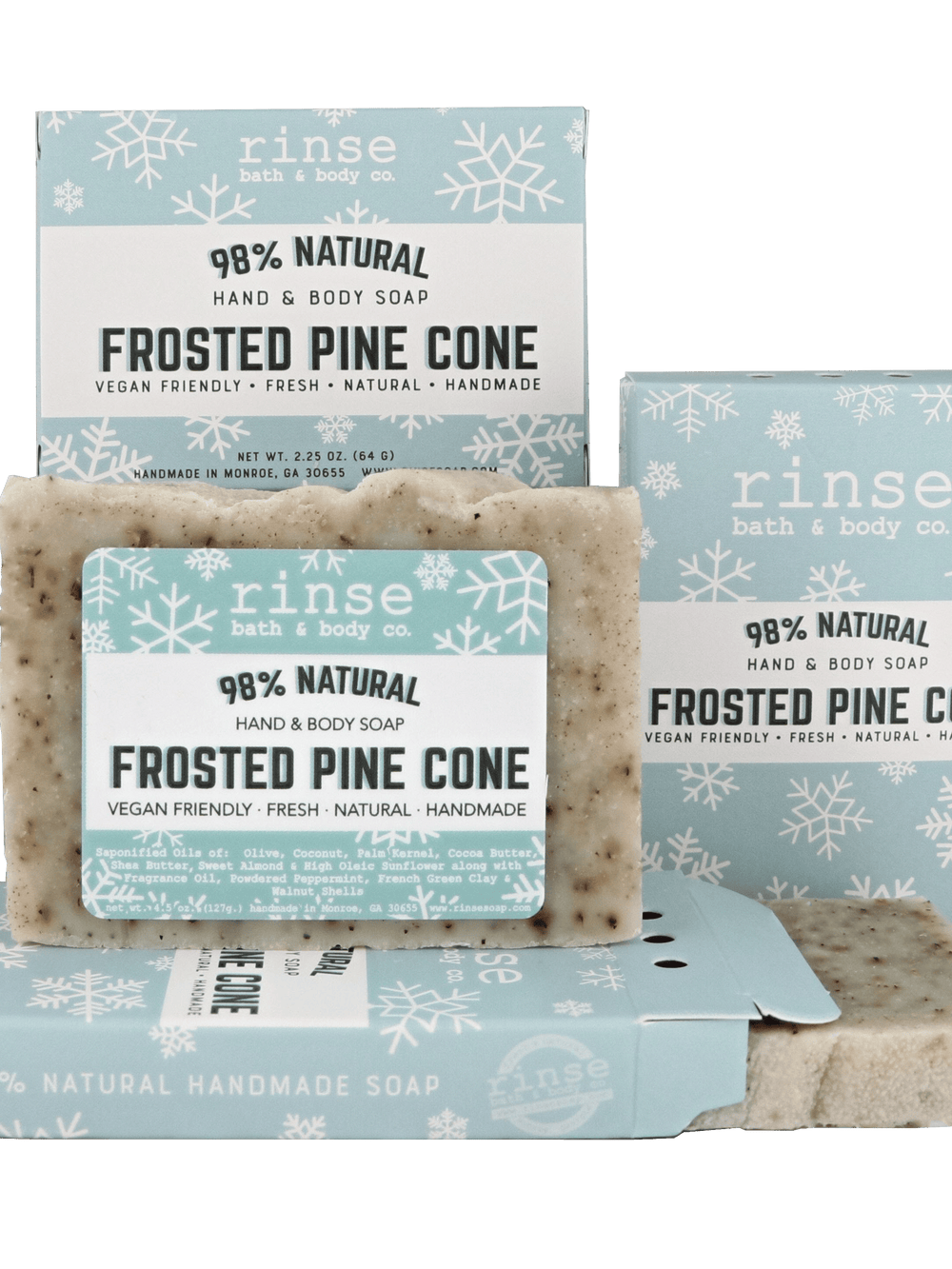 Mini Frosted Pine Cone soap and open snowflake box on deep green — rustic flecked bar in studio contrast