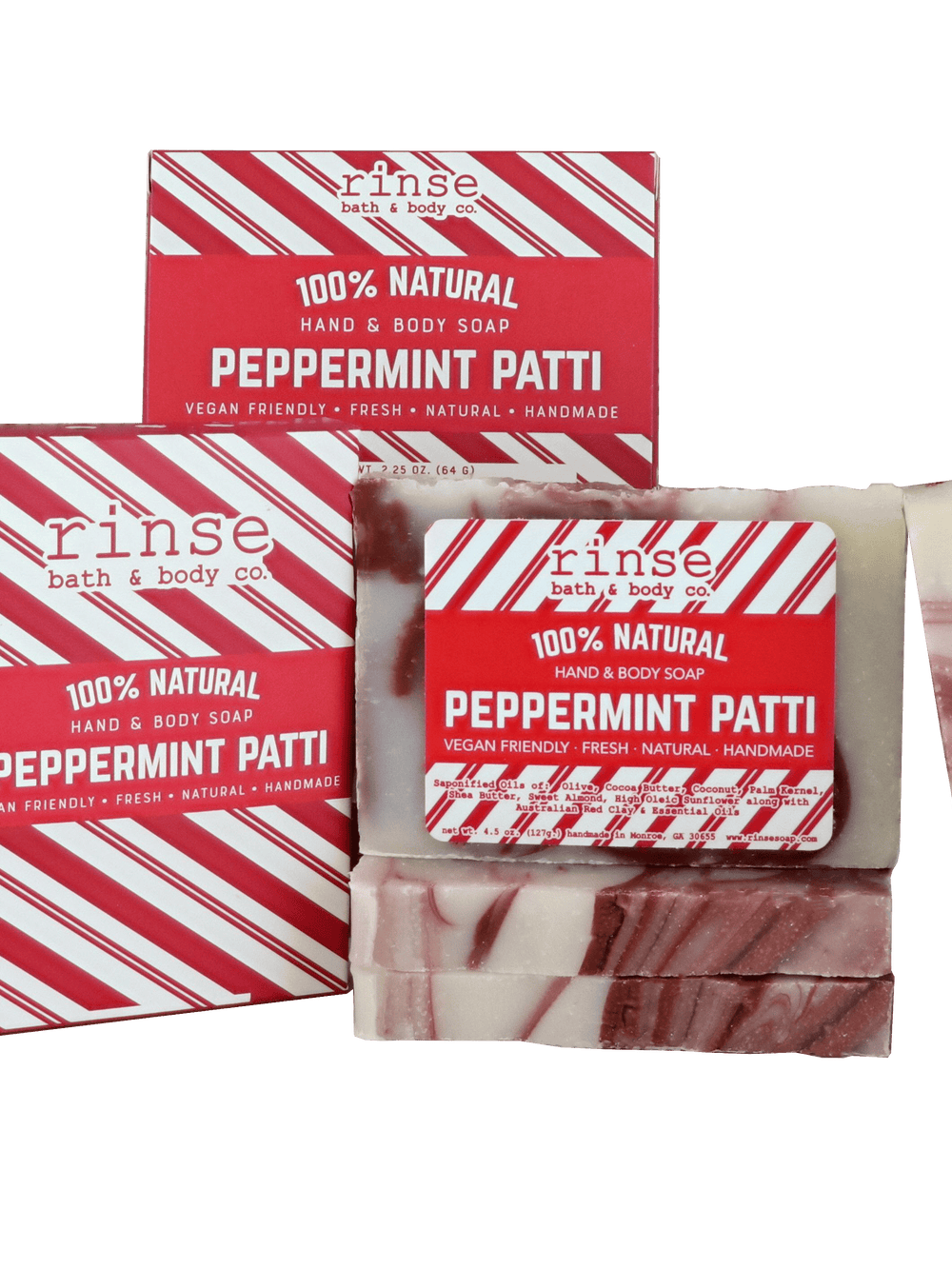 Peppermint Patti bars and holiday boxes arranged on black — red-and-white swirls catching studio light