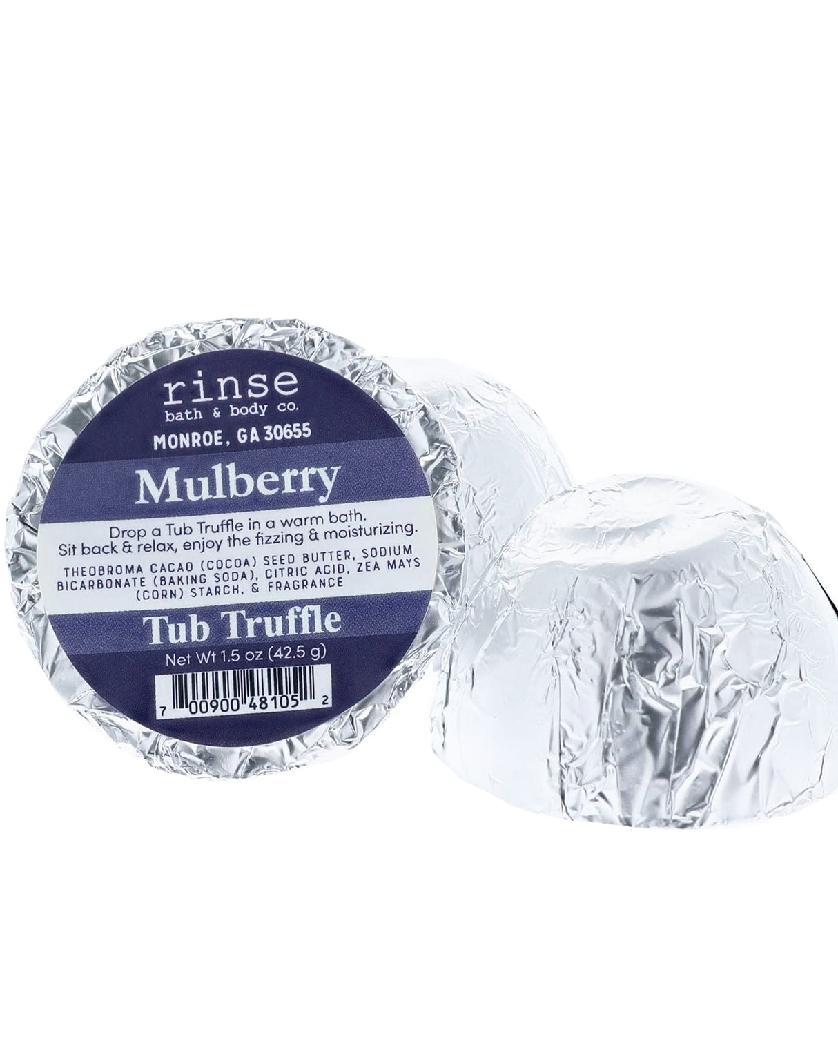 A navy-labelled Mulberry Tub Truffle in silver foil beside a second one cut open to show the cocoa butter dome — dark, jammy, and the whole room knows. Rinse Bath & Body Co.