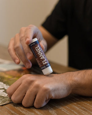 Flannel solid lotion stick smoothed onto skin — sharp musk and clean cotton in a twist-up bar built for hands that work. Rinse Bath & Body Co.