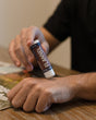 Flannel solid lotion stick smoothed onto skin — sharp musk and clean cotton in a twist-up bar built for hands that work. Rinse Bath & Body Co.