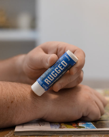 Rugged solid lotion stick — warm woodsy scent in a twist-up bar built for hands that work. Rinse Bath & Body Co.
