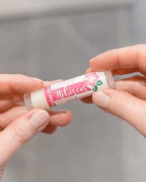Hibiscus lip balm — lightly sweet tropical florals in a cocoa-butter balm. Rinse Bath & Body Co.