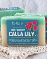 Calla Lily soap rests on white crocheted lace — soft fabric folds and cream teal layers in gentle light