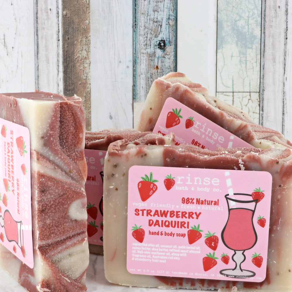 Strawberry Daiquiri soap stack with pink cocktail labels — cream berry swirls against weathered wood