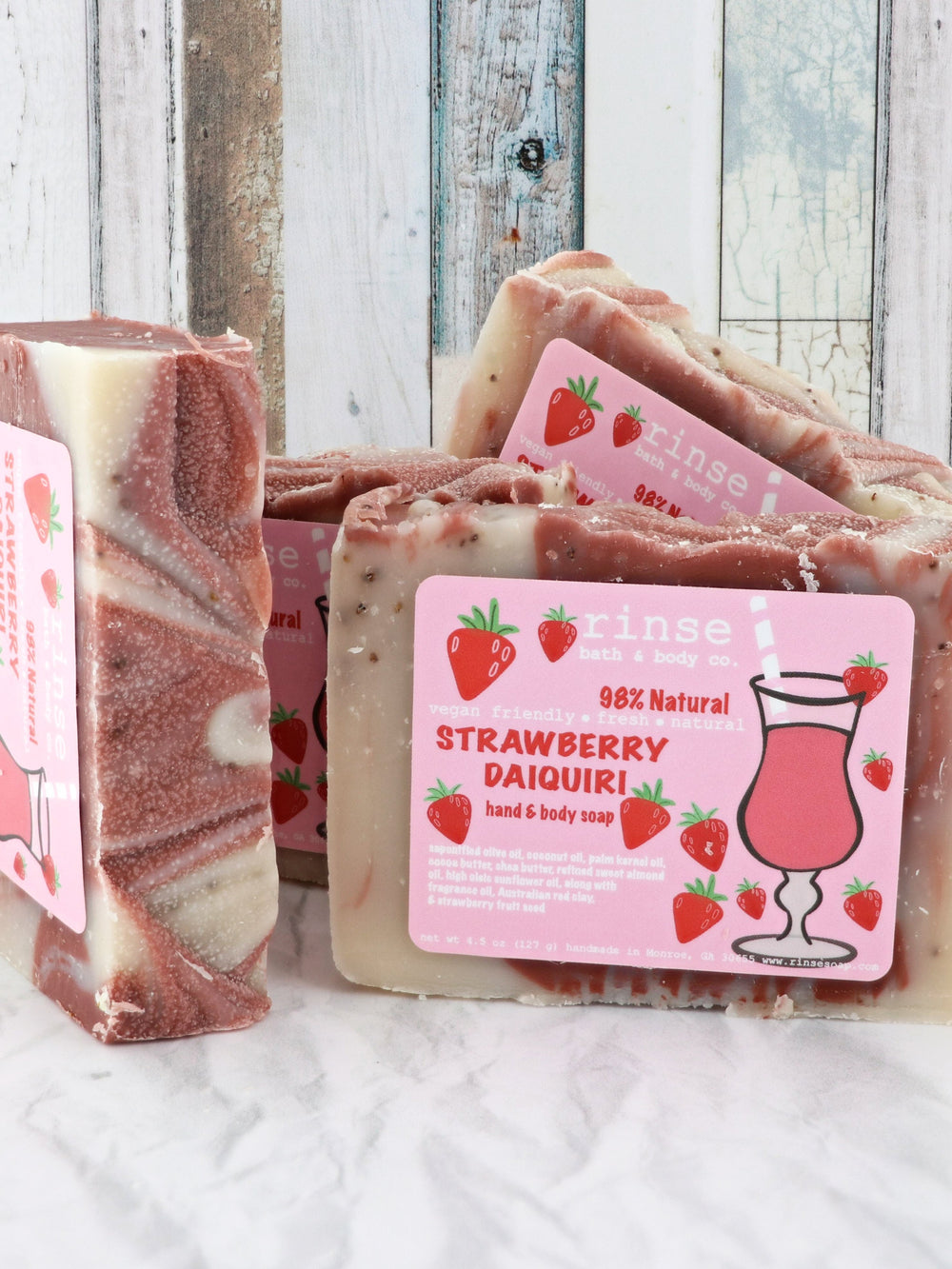 Strawberry Daiquiri soap stack with pink cocktail labels — cream berry swirls against weathered wood