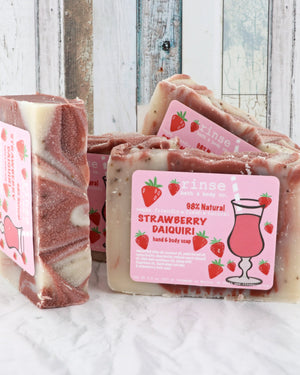 Strawberry Daiquiri soap stack with pink cocktail labels — cream berry swirls against weathered wood