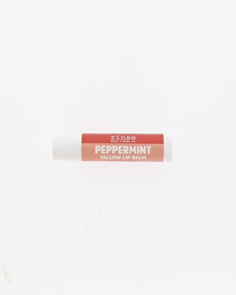 A single tube of Rinse Peppermint Tallow Lip Balm centered on a plain white background.